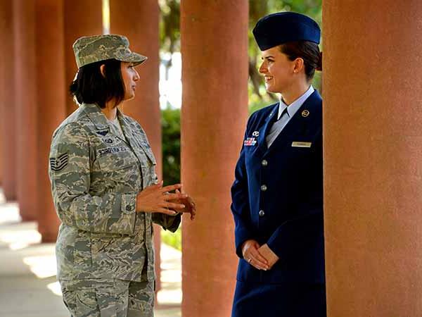 two military students conversing near building 21